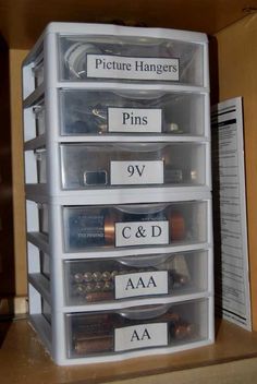 the drawers are labeled with pictures, pins, and other things in their bins