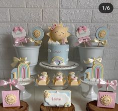 a table topped with cakes and cupcakes covered in fondant