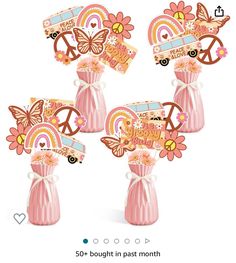 three pink vases with flowers and peace signs on them, each decorated in different colors