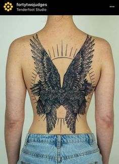 the back of a woman's body with an eagle tattoo on it