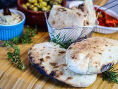 some pita breads are on a wooden table