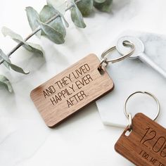 two wooden keychains that say and they lived happily ever after