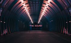 an empty tunnel with the word the sound lit up