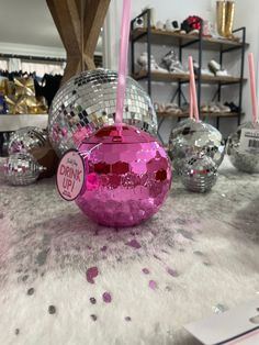 a table topped with disco balls and candles