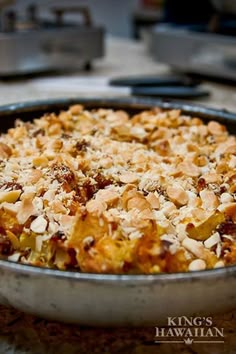 a casserole dish with nuts and other toppings in a pan on the counter