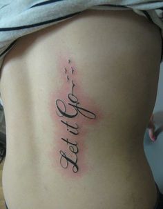 a woman's lower back tattoo with the word faith written in cursive writing