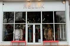 a store front with mannequins in the window