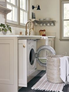 a washer sitting inside of a kitchen next to a window