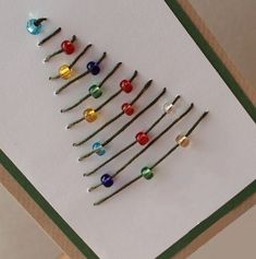 a christmas tree made out of pins on a card