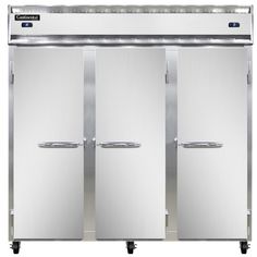 three freezers sitting next to each other on wheels