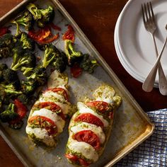 a pan filled with chicken covered in sauce and veggies next to a plate of broccoli