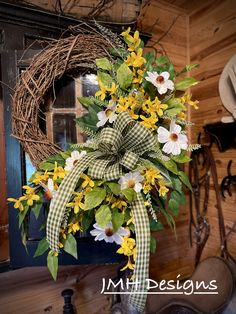 a wreath with yellow and white flowers on it