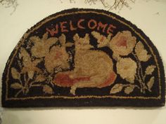 a welcome rug hanging on the wall