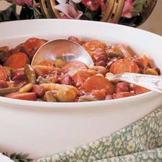 a white bowl filled with stew and vegetables