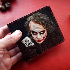 Introducing our stunning handcrafted Joker wallet. - the perfect accessory for everyone who values quality and style.  Crafted with the utmost care and attention to detail, our wallet is made from the finest materials to ensure exceptional durability and longevity. The intricate  Joker design is carefully embossed by hand, giving each piece a unique and distinguished character.  Not only is this wallet stylish, it is also highly practical. With ample space for all of your essential cards and cash, it features multiple card slots, a bill compartment. Whether you're heading out for a night on the town or simply running errands, our dragon-embossed wallet is the perfect accessory to add a touch of sophistication to your style.  Experience the perfect blend of functionality and style with our Custom Handmade Trifold Wallet, Custom Handmade Rectangular Trifold Wallet, Luxury Handmade Wallets For Everyday Use, Luxury Handmade Wallets, Custom Black Handmade Trifold Wallet, Luxury Handmade Wallets For Gifts, Joker Design, Tooled Wallet, Handmade Wallet