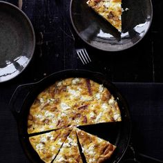 there is a pizza in the pan with one slice cut out and another on the plate