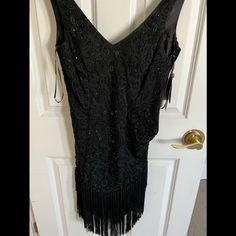 Lovely Fringed Black Short Dress Size Small Never Worn New With Tags Black V-neck Flapper Dress For Party, Black V-neck Flapper Dress For Evening, Fitted Flapper Dress For Holiday Evening, Fitted Flapper Evening Dress For Holiday, Elegant Fitted Flapper Dress For Night Out, Elegant V-neck Flapper Dress For Night Out, Elegant Fitted Flapper Dress For Evening, Elegant Holiday Flapper Dress For Cocktail Parties, Elegant Holiday Cocktail Flapper Dress