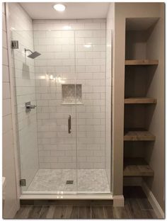 a walk in shower sitting next to a shelf filled with shelves and bookshelves