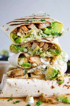 three burritos stacked on top of each other with meat and veggies