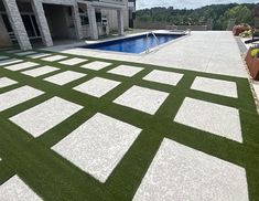 an outdoor swimming pool with artificial grass