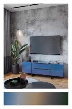 a living room with a large tv on the wall and a blue cabinet in front of it