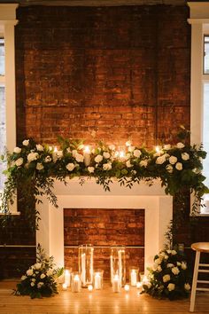 the fireplace is decorated with candles and flowers