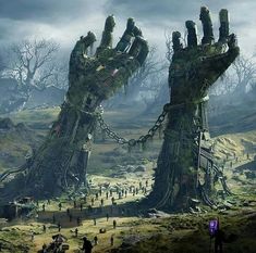 two giant hands are chained to the ground in front of some people on a hill