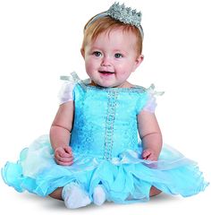 a baby girl wearing a blue dress and a tiara