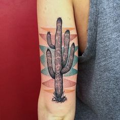 a woman's arm with a cactus tattoo on it