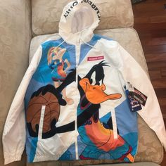 Space Jam Looney Tunes Windbreaker Jacket Size Large New With Tags Members Only Brand Casual Hooded Sport Coat For Spring, White Long Sleeve Raincoat For Fall, Trendy White Hooded Track Jacket, Casual White Sport Coat For Streetwear, Casual White Nylon Outerwear, White Casual Raincoat For Fall, Casual White Long Sleeve Sport Coat, White Long Sleeve Raincoat With Pockets, Trendy White Outdoor Outerwear