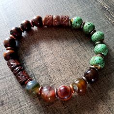 One Of A Kind Artisan Crafted Men's Bracelet, Made With Fire Agate Known As The Warrior Stone, For Courage, Strength, And Protection, Also Carved Wood Beads And Glazed Stoneware. Just Add A Drop Of Your Favorite Essential Oil. The Warrior, Fire Agate, Men's Bracelet, Mens Accessories Jewelry, Artisan Craft, Carved Wood, Wood Beads, Aromatherapy, Mens Bracelet