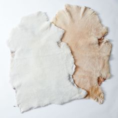 two pieces of white and beige colored paper