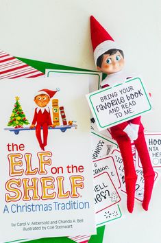 the elf on the shelf is next to some christmas cards