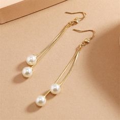 Drop earrings featuring a dangly tassel motif created with shining 18k gold-plated and accented with sparkling cubic zirconia and pearls. 0.31" W x 2.76" L 18k gold-plated copper / cubic zirconia / pearl Tassel Drop Earrings, Bridal Accessories, Cubic Zirconia, Tassels, 18k Gold, Gold Plate, Copper, Sparkle, Plating