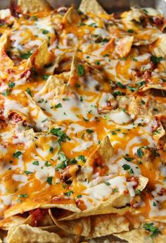 nachos with cheese and toppings in a pan