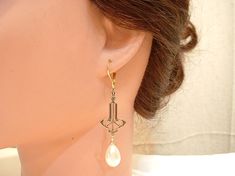 "Offering a pair of vintage inspired Art Nouveau / Art Deco style ivory pearl drop Downton Abbey statement earrings. These look like they were transported from the days of the Speakeasy and will be as perfect with a pair of jeans and a tee as a Bridal gown. Earrings hang down just under 2 1/2 inches (6.4 cm) from the TOP of the ear wire. I love the design of these treasures! High quality, lustrous teardrop shaped ivory glass pearls hang from elegant antique gold colored SO 1910s to 1920s designe Gown Earrings, 1920s Earrings, Bridal Dangle Earrings, Vintage Rhinestone Jewelry, Vintage Inspired Art, Art Deco 1920s, Art Nouveau Art, Nouveau Art, Pearl Bridal