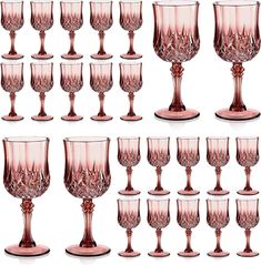 a set of twelve pink glass goblets sitting next to each other