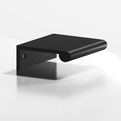 a black square object sitting on top of a white table with light coming through it