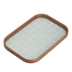 a brown and white tray with an intricate design on the bottom, in front of a white background