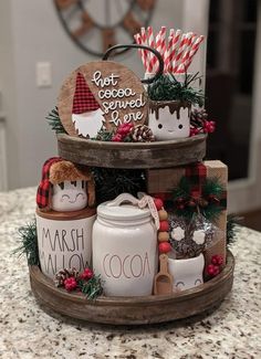 two tiered trays filled with christmas decorations and candy canes on top of a counter