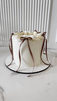 a white cake with chocolate ribbons on top