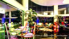 the interior of a restaurant with colorful chairs and tables