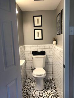 a white toilet sitting in a bathroom next to a sink