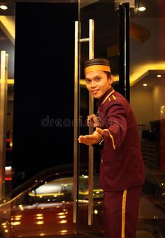 a young man in uniform is holding on to the glass door royalty images and clippings