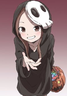 a girl in a black hoodie with a white mask on her head holding a pumpkin