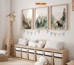 there are three pictures hanging on the wall in this room, and one has a giraffe