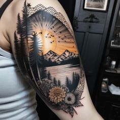 a woman's arm with a sunset and trees tattoo on the left side of her body