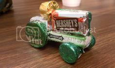 hershey's milk chocolates and mint candy on a wooden table next to a glass of milk