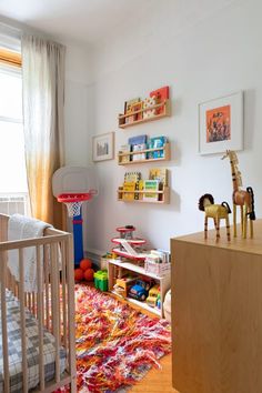 a child's room with toys and decor on the walls, including a crib