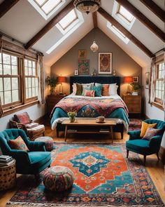 a bedroom with an orange and blue rug on the floor, two chairs, a bed and windows